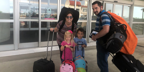 The Bradley family at the airport with bags ready to travel