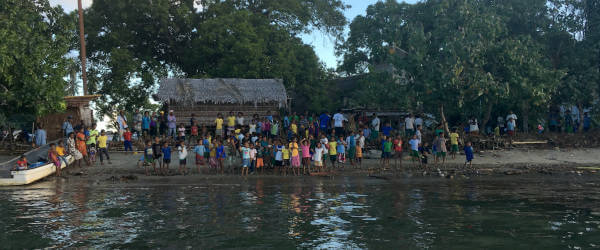 Papuans crowded at the beach on Fergusson Island
