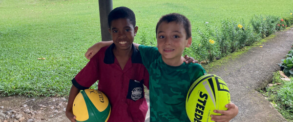 Andrew and his friend, Luca, with their rugby balls